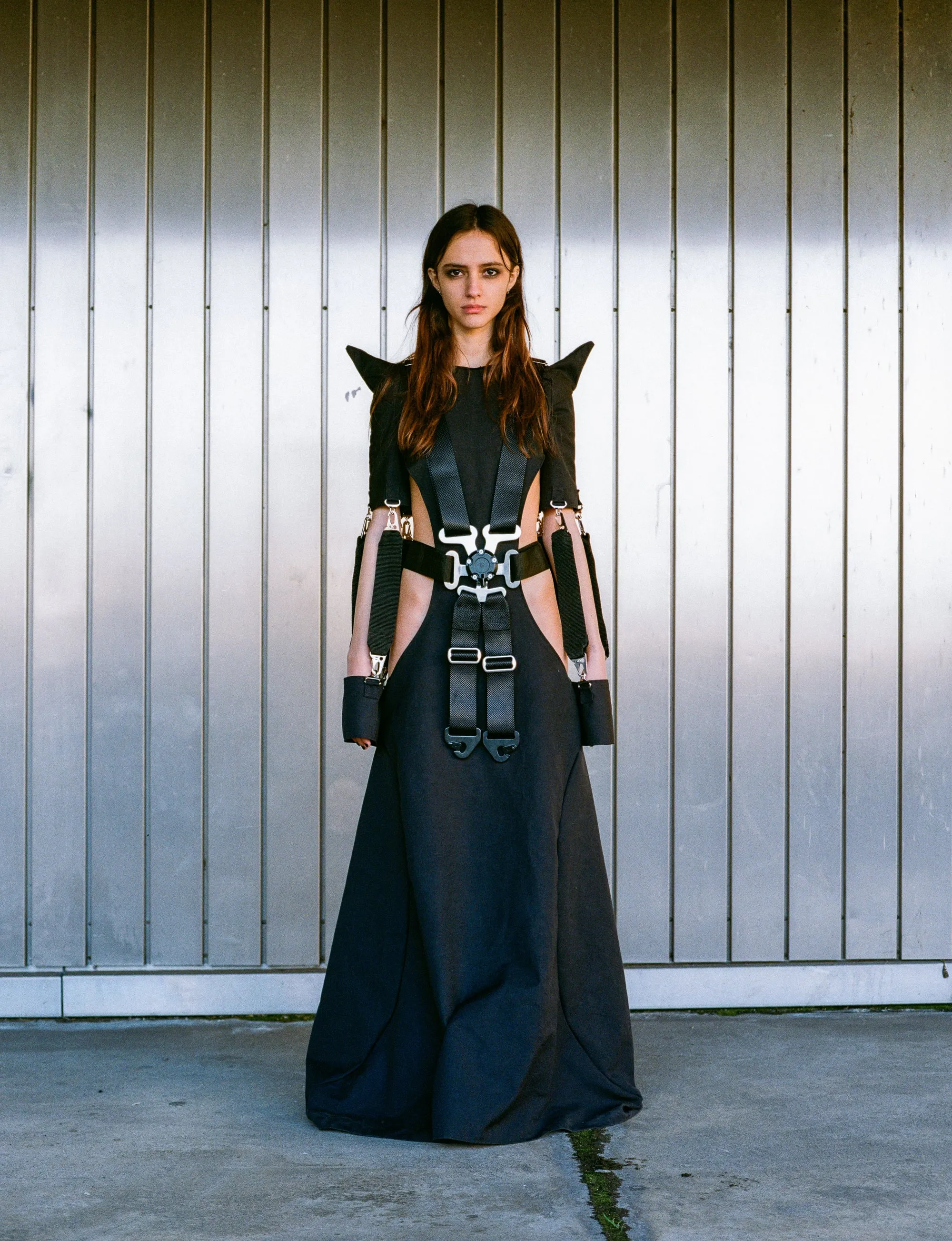Racing 6-Point Belt Dress by GÖRE — full-length front view against a corrugated metal wall