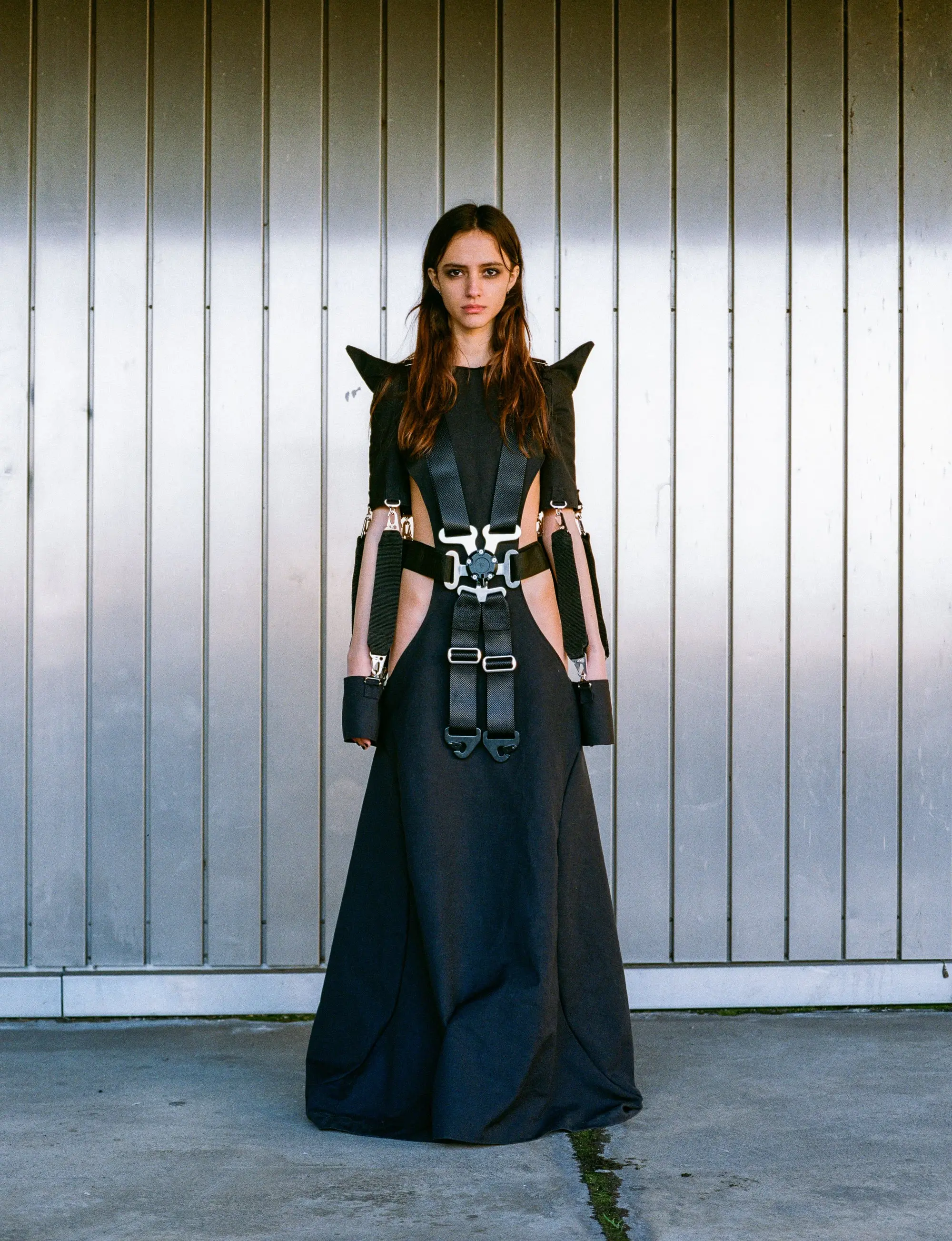 Racing 6-Point Belt Dress by GÖRE — full-length front view against a corrugated metal wall