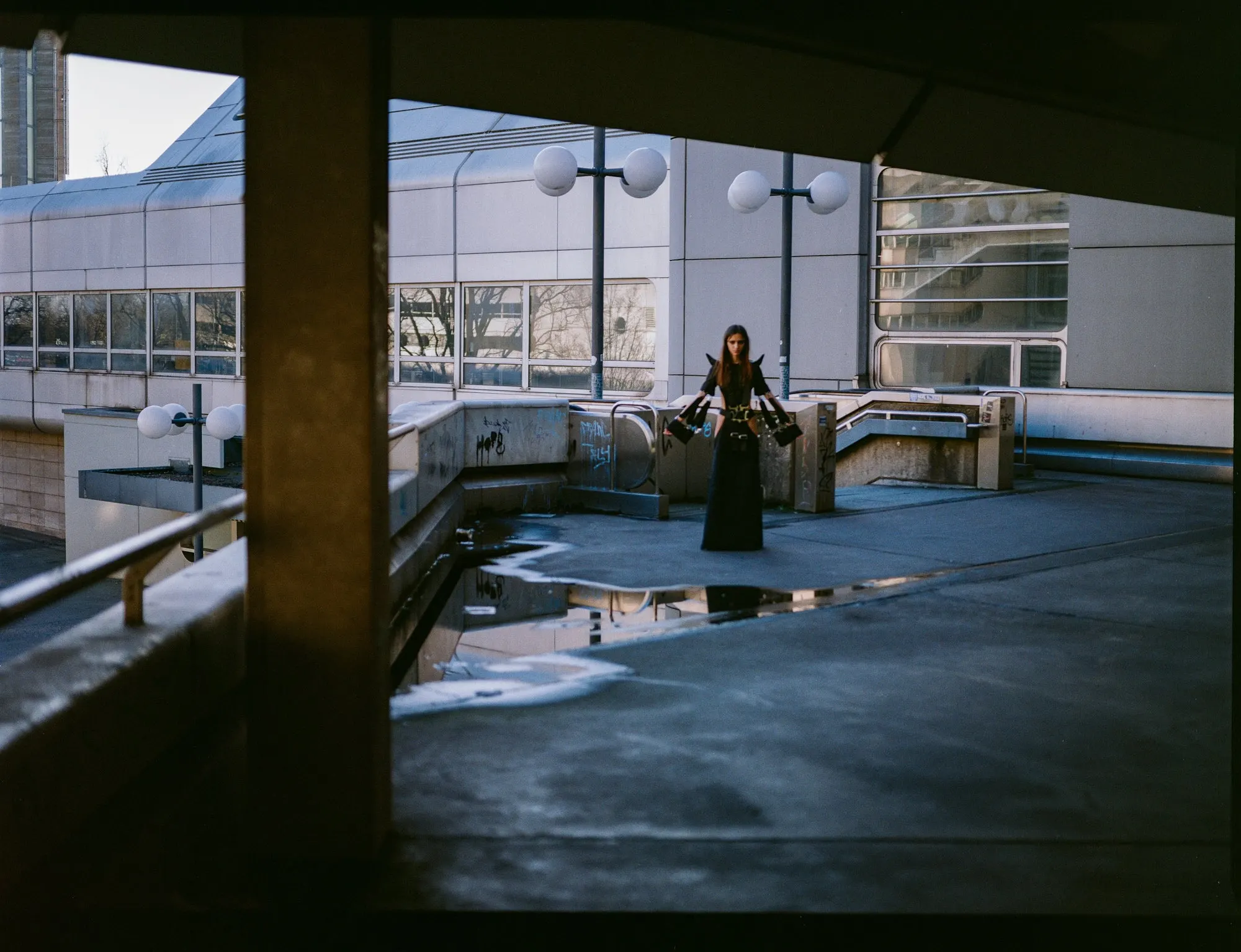 Racing 6-Point Belt Dress — model on a rooftop parking deck at dusk