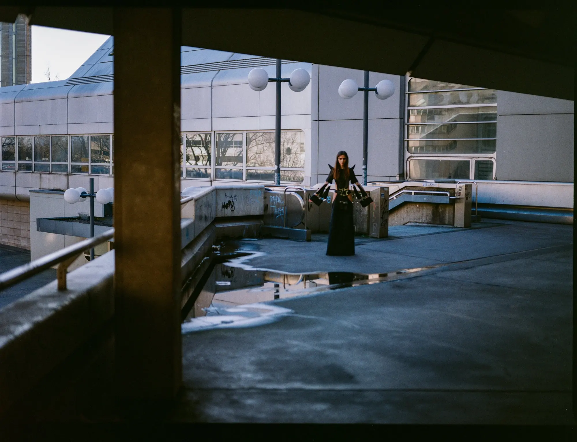 Racing 6-Point Belt Dress — model on a rooftop parking deck at dusk