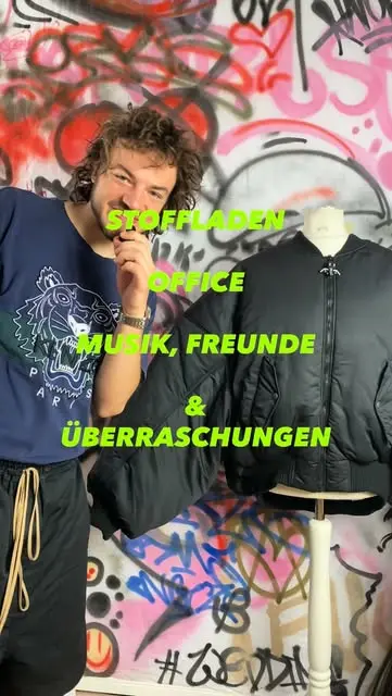 Moritz Wanya in front of a graffiti wall — Stoffladen, Office, Musik, Freunde & Überraschungen