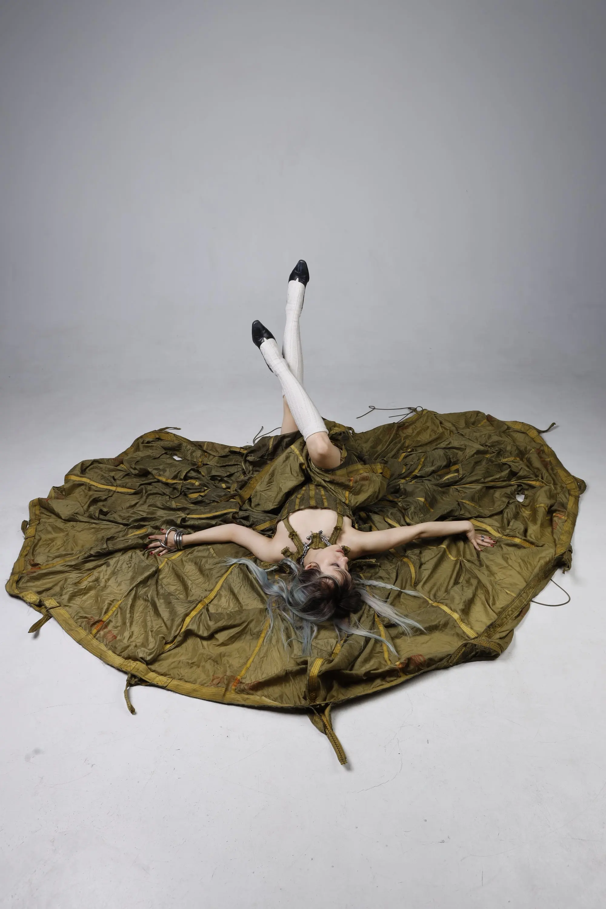 Parachute Dress — model lying on the floor, canopy spread out in a circle