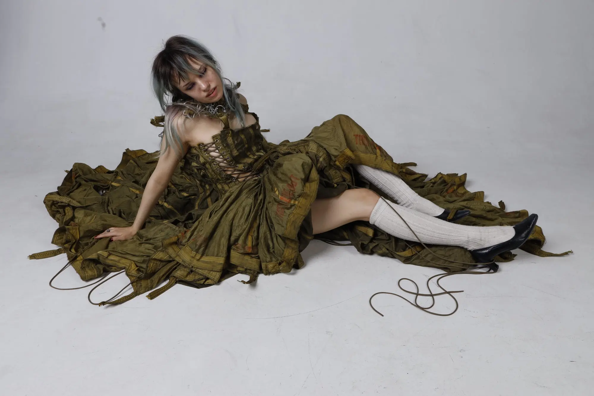Parachute Dress — landscape editorial, model resting on the spread parachute