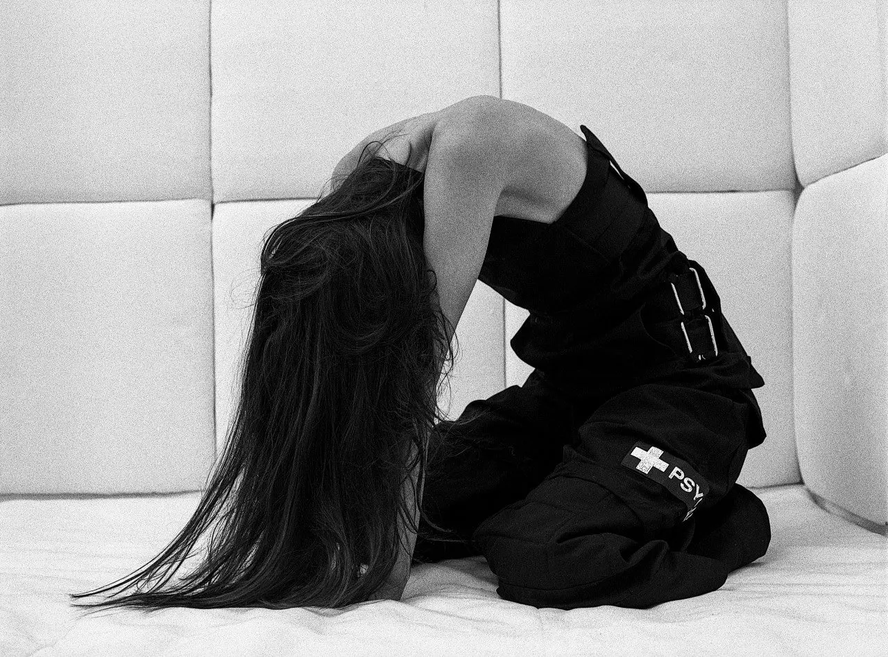 PsyCare campaign — model in the padded PsyCare worker pants, kneeling on a white padded floor