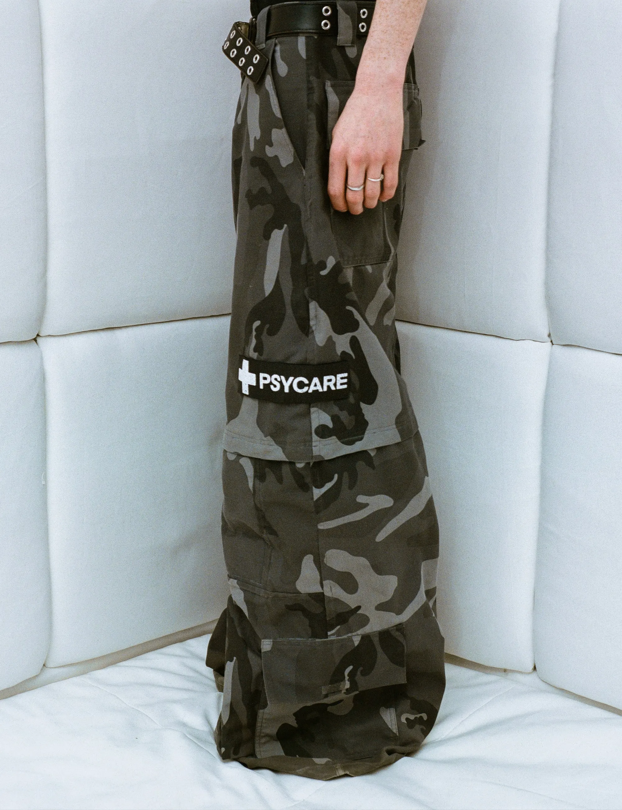 PsyCare worker pants — camouflage cargo trousers with padded knees and a PSYCARE patch