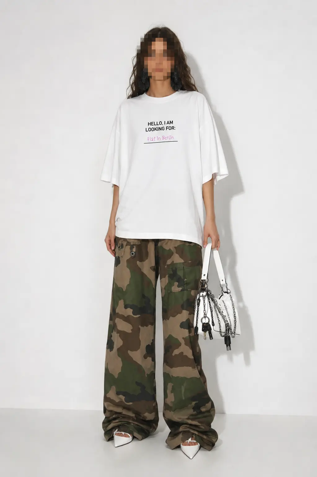 Model wearing the ?Flat? Berlin Shirt with black print, styled with camouflage trousers