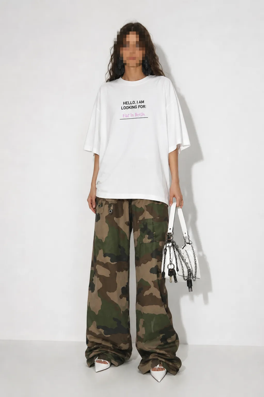 Model wearing the ?Flat? Berlin Shirt with black print, styled with camouflage trousers