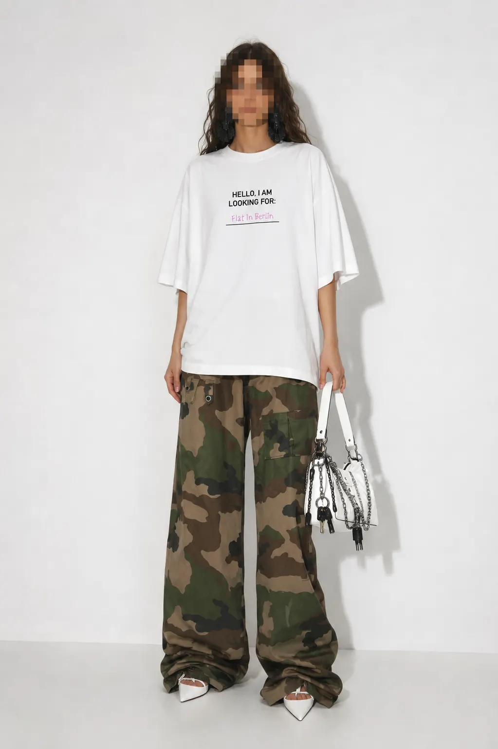 Model wearing the ?Flat? Berlin Shirt with black print, styled with camouflage trousers